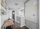 Upstairs hallway offers a glimpse of natural light and neutral-toned walls at 1225 Greenley Ave, Groveland, FL 34736