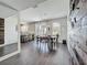 Open dining area with chandelier lighting, a view of the kitchen and feature wall at 1225 Greenley Ave, Groveland, FL 34736