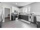 Well-lit kitchen featuring stainless steel appliances, subway tile backsplash, and gray cabinets at 1225 Greenley Ave, Groveland, FL 34736