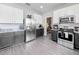 Modern kitchen featuring stainless steel appliances, gray cabinets, and subway tile backsplash at 1225 Greenley Ave, Groveland, FL 34736