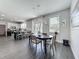 Open-concept dining area next to kitchen with modern light fixture and ample natural light at 1225 Greenley Ave, Groveland, FL 34736