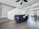 Inviting living space featuring a modern sofa, open floor plan, and ample natural light at 1225 Greenley Ave, Groveland, FL 34736