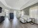 Spacious main bedroom with stylish decor, wood-look floors, and ample natural light at 1225 Greenley Ave, Groveland, FL 34736