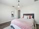 Cozy bedroom with a plush rug, elegant chandelier, and a comfortable bed dressed with soft linens and decorative pillows at 1225 Greenley Ave, Groveland, FL 34736