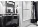 Modern bathroom features black cabinets, subway tiles, and a tub with shower at 1581 Forest Ave, Winter Park, FL 32789