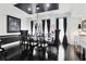 This dining room features black hardwood floors and a sleek black ceiling accent at 1581 Forest Ave, Winter Park, FL 32789