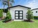 Charming exterior of a home with symmetrical landscaping, vibrant green lawn, and modern design at 1581 Forest Ave, Winter Park, FL 32789