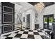Elegant foyer features black-and-white checkered floors, a dazzling chandelier, and grand staircase at 1581 Forest Ave, Winter Park, FL 32789