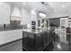 Modern kitchen with sleek countertops, stainless steel appliances, and an open view to the living area at 1581 Forest Ave, Winter Park, FL 32789