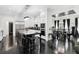 Open kitchen featuring an island with seating, stainless appliances, and hardwood floors with dining area view at 1581 Forest Ave, Winter Park, FL 32789