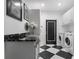 Well-equipped laundry room with modern appliances, storage cabinets, and granite countertop at 1581 Forest Ave, Winter Park, FL 32789