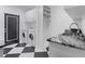 Bright laundry area with modern washer and dryer, contrasting flooring, and stainless sink at 1581 Forest Ave, Winter Park, FL 32789