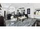 Open-concept living room with modern decor, hardwood floors, and a seamless flow to the kitchen at 1581 Forest Ave, Winter Park, FL 32789