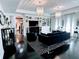 Bright living room with floor to ceiling shelving and a large chandelier at 1581 Forest Ave, Winter Park, FL 32789