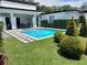 Backyard pool with fountains, patio area, and lush landscaping for ultimate relaxation at 1581 Forest Ave, Winter Park, FL 32789