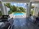 Inviting outdoor pool area with covered seating and well-manicured landscaping at 1581 Forest Ave, Winter Park, FL 32789