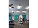 Bright gym featuring treadmills, weight machines, ceiling fans, and access to the pool area for exercise and wellness at 528 Bridgeford Crossing Blvd, Davenport, FL 33837