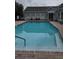 Inviting community pool with clear blue water, surrounded by brick pavers and a building with black-trimmed windows at 528 Bridgeford Crossing Blvd, Davenport, FL 33837