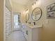 Contemporary bathroom with double sinks, stylish mirrors, and walk-in shower at 554 Estates Pl, Longwood, FL 32779