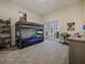Spacious bedroom with a bunk bed, workspace, and outdoor access at 554 Estates Pl, Longwood, FL 32779