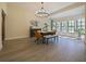 Inviting dining room features a large table, chandelier, and plentiful natural light from the large windows at 554 Estates Pl, Longwood, FL 32779