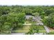 Exterior aerial showcasing property nestled among mature trees and greenery, with a long driveway at 554 Estates Pl, Longwood, FL 32779