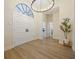 Bright entryway with double doors, a transom window, and elegant wood-look flooring for a grand welcome at 554 Estates Pl, Longwood, FL 32779