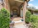 Charming front porch with brick accents, featuring a stylish entrance and well-maintained landscaping at 554 Estates Pl, Longwood, FL 32779