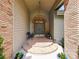 Inviting front porch with brick columns, featuring a double front door, landscaping, and charming details at 554 Estates Pl, Longwood, FL 32779