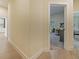 Hallway view into a bedroom with carpet, desk, and modern window at 554 Estates Pl, Longwood, FL 32779