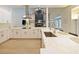 Modern kitchen features white cabinetry, stainless steel appliances, and a waterfall island, perfect for cooking at 554 Estates Pl, Longwood, FL 32779