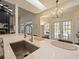 Kitchen showcasing breakfast bar, view of black fireplace and backyard pool from the open layout at 554 Estates Pl, Longwood, FL 32779