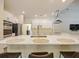 Bright open-concept kitchen features a breakfast bar with seating, white cabinets, and stainless steel appliances at 554 Estates Pl, Longwood, FL 32779
