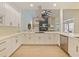 Updated kitchen showcases white cabinetry, modern hardware, stainless steel appliances, and sleek countertops at 554 Estates Pl, Longwood, FL 32779