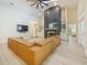 Bright living room with a modern fireplace, leather sectional, and open layout, perfect for relaxation and entertainment at 554 Estates Pl, Longwood, FL 32779