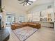 Spacious living room boasts a large sectional sofa, fireplace and views to the modern kitchen and outdoor pool at 554 Estates Pl, Longwood, FL 32779