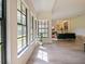 Bright living room with large windows, plant, and elegant furnishings offers a welcoming space at 554 Estates Pl, Longwood, FL 32779