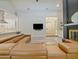 Open-concept living room with a fireplace, large sectional sofa, and views into the modern kitchen and foyer at 554 Estates Pl, Longwood, FL 32779