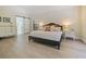 Serene main bedroom featuring neutral tones, ample natural light, and an ensuite bathroom with a sliding barn door at 554 Estates Pl, Longwood, FL 32779