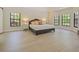 Spacious bedroom with tray ceiling, wood floors and natural light from ample windows create a serene retreat at 554 Estates Pl, Longwood, FL 32779