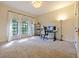 Spacious home office with modern lighting, arched windows and a dedicated computer setup at 554 Estates Pl, Longwood, FL 32779