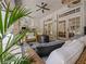 Lovely outdoor living area with rattan furniture, overhead lighting, and a view of the screened pool area at 554 Estates Pl, Longwood, FL 32779