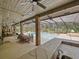 A vast covered pool area offering both an outdoor dining area as well as kitchen with bar and a clear view of the pool at 554 Estates Pl, Longwood, FL 32779