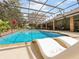 Beautiful screened-in pool with brick trim, lounge chairs, and an outdoor dining area offers a relaxing retreat at 554 Estates Pl, Longwood, FL 32779