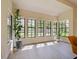 Bright sunroom features a wall of windows bringing the outdoors in, with natural light and potted plants at 554 Estates Pl, Longwood, FL 32779