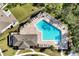 Aerial view of a community pool with lounge chairs and lush landscaping at 10002 Brown Burrow St, Orlando, FL 32829