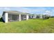 Expansive backyard featuring green lawn with a screened patio at 10002 Brown Burrow St, Orlando, FL 32829