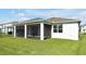 Spacious backyard with well-maintained lawn and screened-in lanai at 10002 Brown Burrow St, Orlando, FL 32829