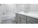 Well-lit bathroom features a shower-tub combo, white countertop, and ample cabinet space at 10002 Brown Burrow St, Orlando, FL 32829