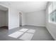 Bright, minimalist bedroom with neutral walls and large windows for natural light at 10002 Brown Burrow St, Orlando, FL 32829